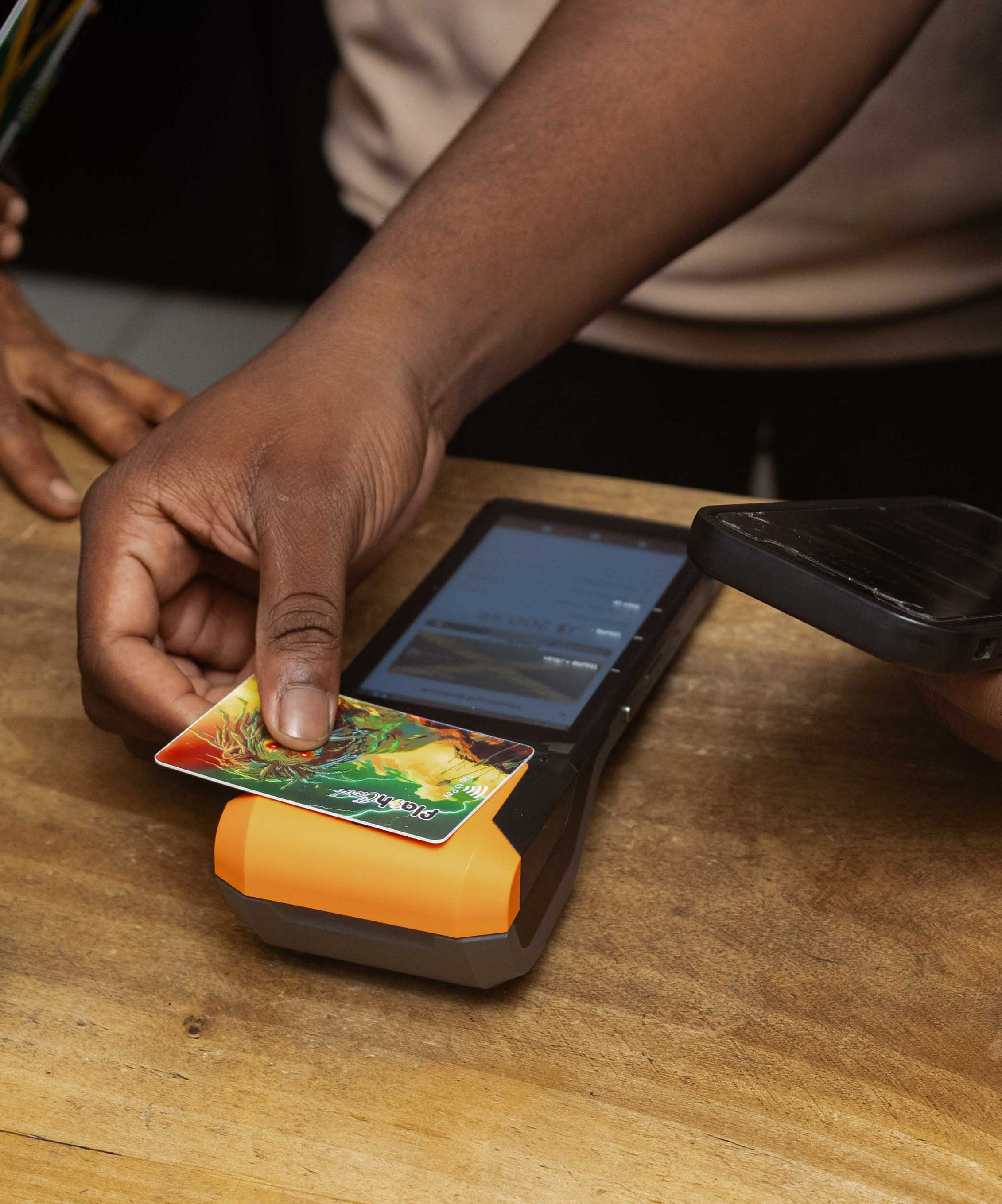 Customer tapping a Flash card at a merchant POS terminal
